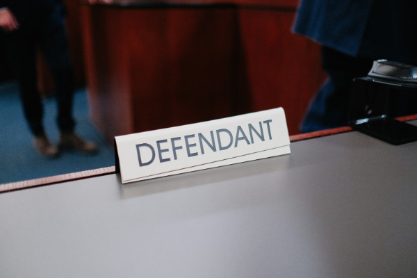 Sign on a table saying 'defendant