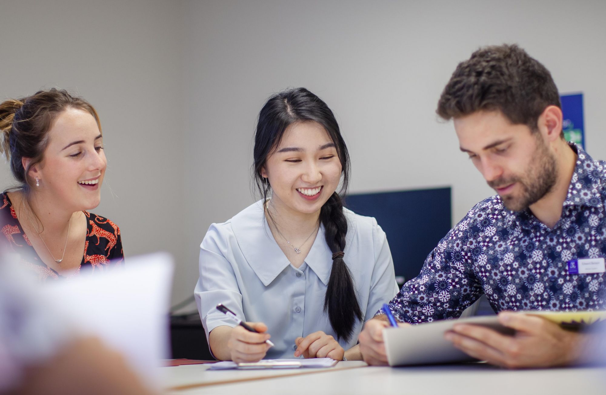 Students discussing topics at a table