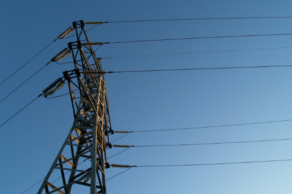 Looking up at a large power line.