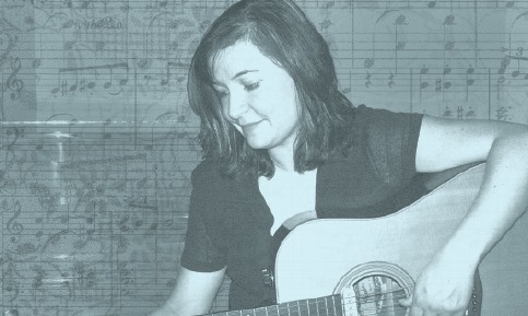 Anne Horne-Thompson playing guitar.