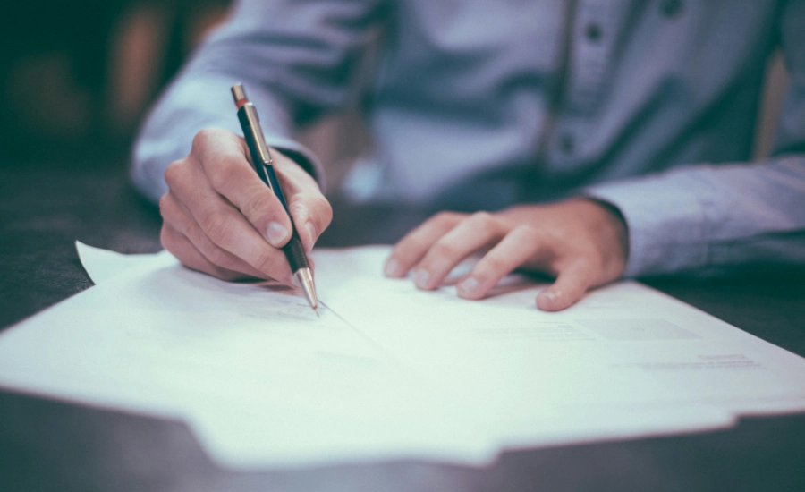 Man writing on paper.